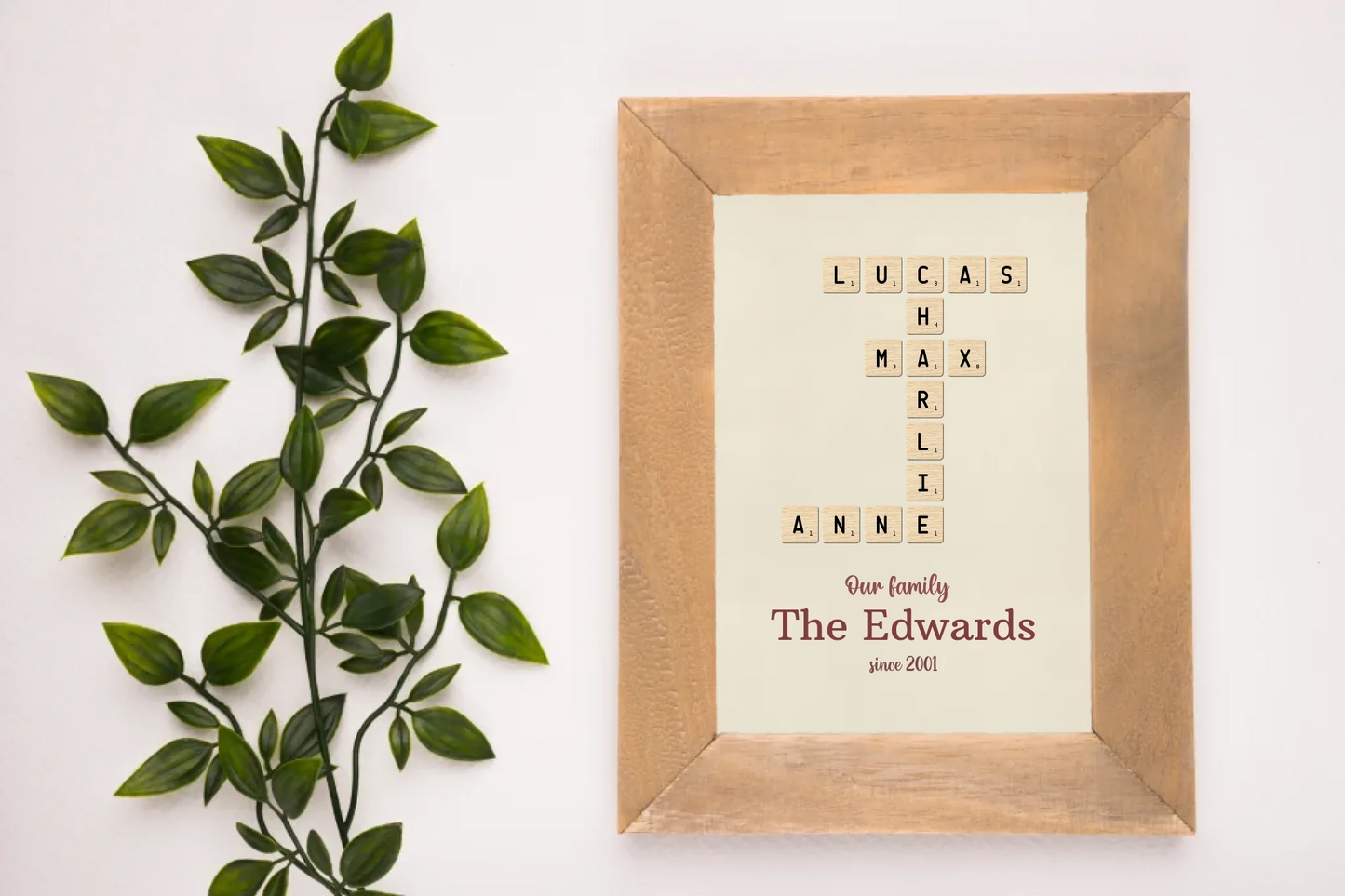 artificial-green-plant-near-wooden-frame-white-backdrop